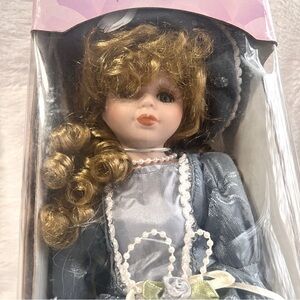 Collectible Porcelain Doll with Brown Curl Hair Blue Dress Blue Hat with Stand